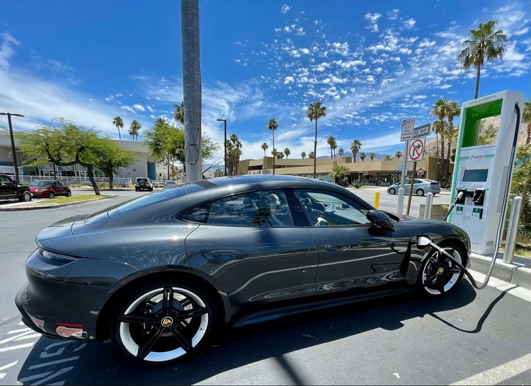 Pursche Taycan (electric sports sedan) parked at electric charging station