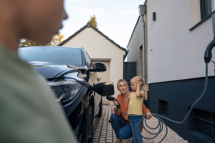 A girl and her mom charging an EV